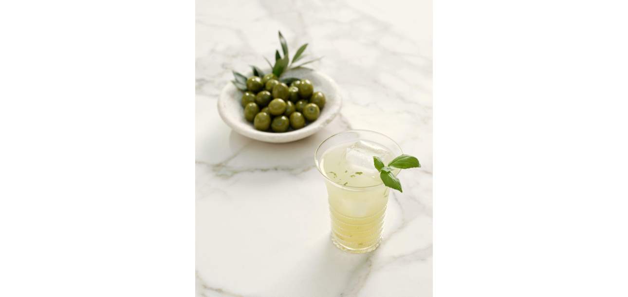 Basil Spritz Cocktail and a bowl of olives