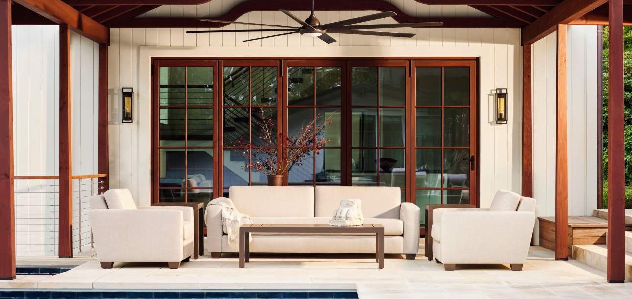 McKinnon and Harris Peristyle Sofa and Cub Chairs poolside under a pavilion
