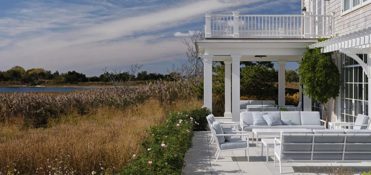 deCamp Club Chairs and deCamp Sofas shown in Classic White with La Dolce Vita Pickling Fabric; Throw Pillows shown in Mediterraneo Duck Egg Fabric; Wyatt Coffee and Side Tables shown in Classic White. Design by Victoria Hagan Interiors. Photo by Douglas Friedman.