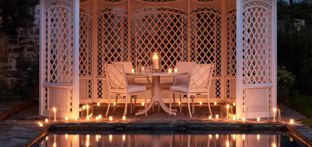 Otey Dining Chairs around a round dining table with votive candles