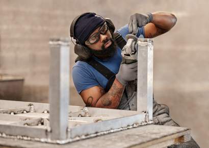 McKinnon and Harris craftsperson sculpting a Parsons Coffee Table
