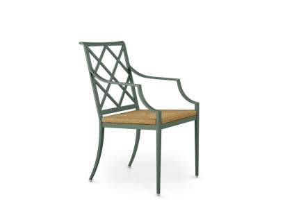 The Otey Dining Arm Chair with Rush Seat in Atlantic Green, featuring a Chinoiserie fretwork-inspired back design, sculpted arms, and a woven natural rush seat.
