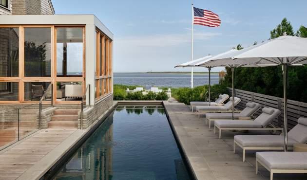 Waterfront installation with McKinnon and Harris sun chaises poolside. Design by Workshop APD, Photos by Read McKendree.