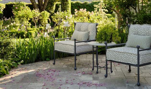 McKinnon and Harris Thirza Club Chairs and Thirza Side Table with Natural Stone Top at a garden in Napa Valley, CA. Design by Suzanne Tucker / Tucker & Marks.