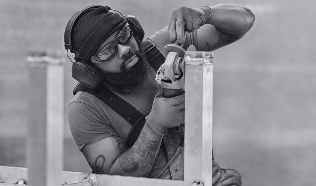 McKinnon and Harris craftsperson sculpting a Parsons Coffee Table