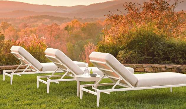 McKinnon and Harris deCamp Sun Chaise overlooking a mountain range as the sun sets
