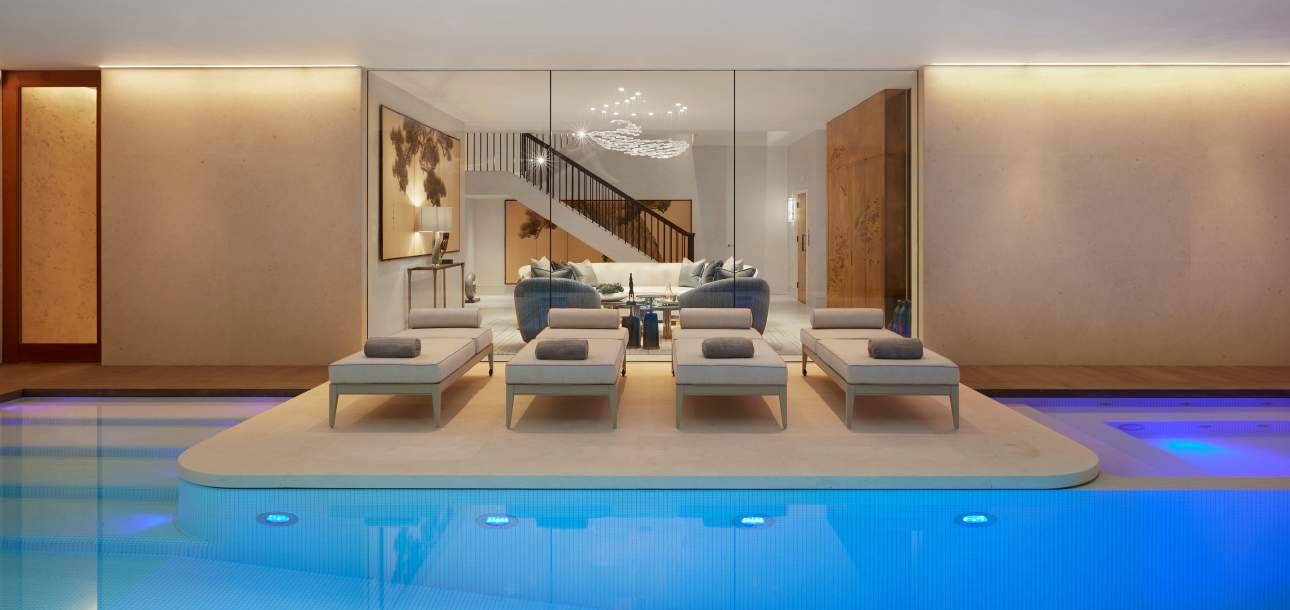 McKinnon and Harris duVal Sun Chaises next to an indoor pool at a home in Notting Hill, London. Design by Katharine Pooley.