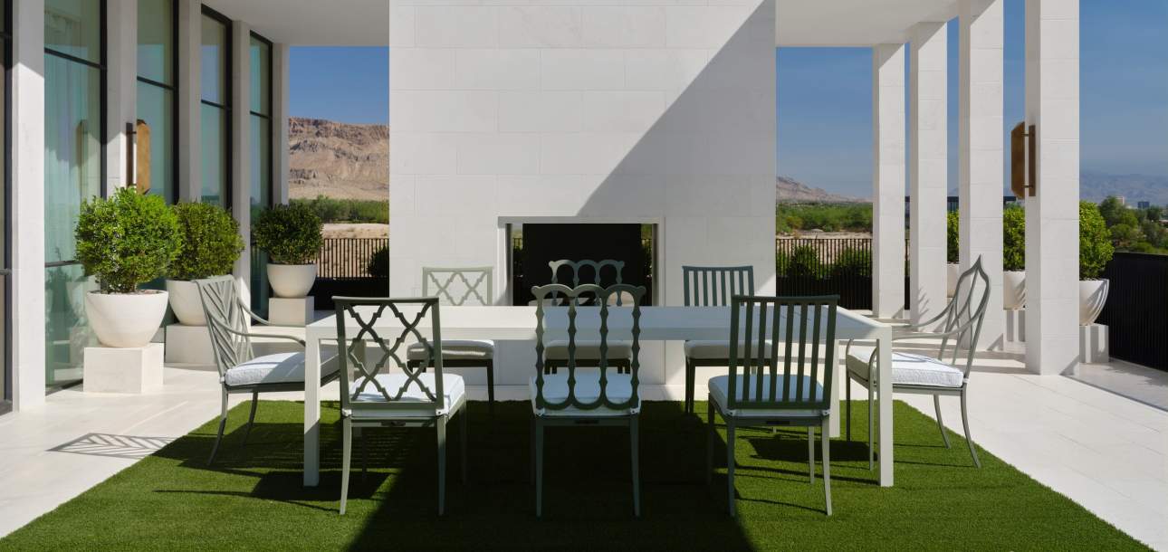 An assortment of McKinnon and Harris dining chairs around a Parsons Dining Table at a modern home in Las Vegas, Nevada. Design by Daniel Joseph Chenin.