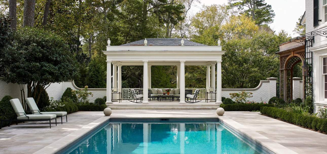 McKinnon and Harris Otey Sun Chaises and Rocking Chairs poolside at a home in Atlanta, Georgia. Design by Williams Lawrence.