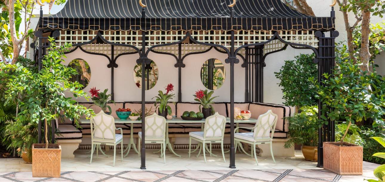 McKinnon and Harris Douglas Dining Chairs under a loggia. Design by Besty Shiverick Interiors.