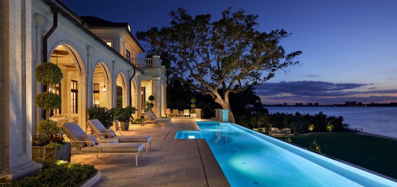 McKinnon and Harris Otey Sun Chaises poolside at a home in Florida. Design by Heather Wells.