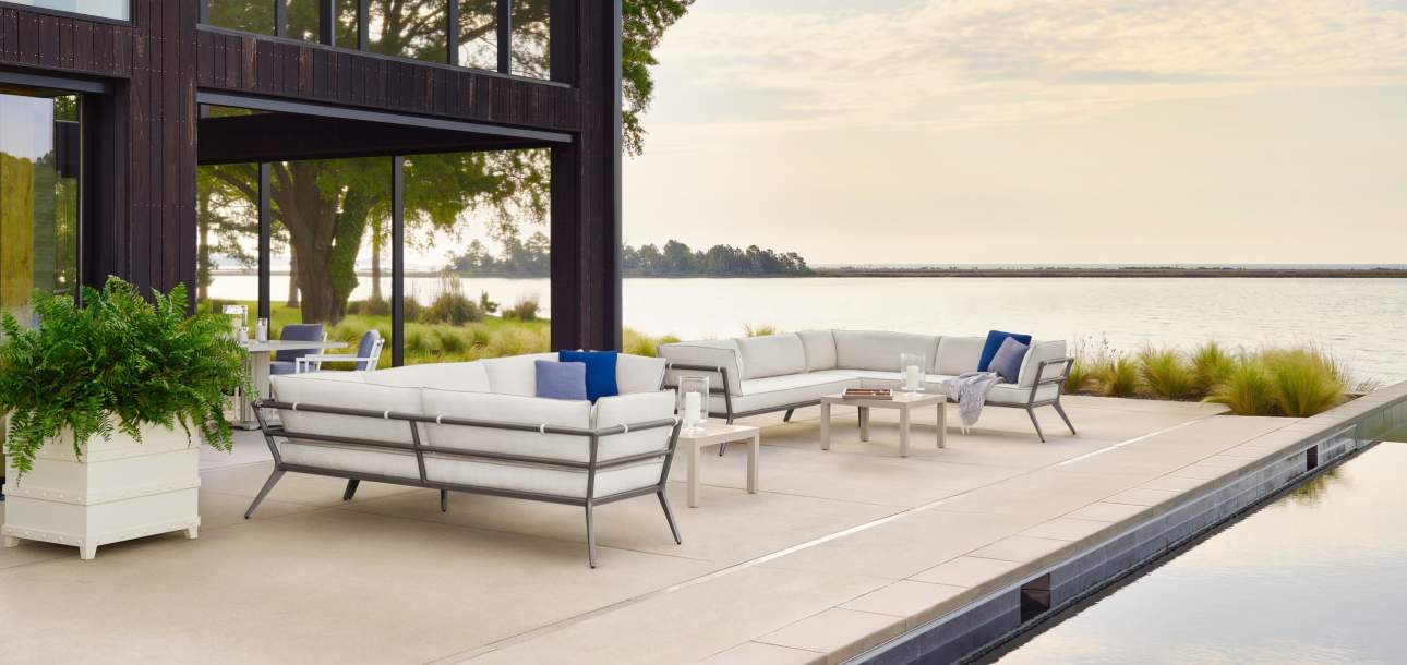 deCamp Sectional Ensemble finished in Natural Bronze paired with Wyatt Rectangular Coffee Tables