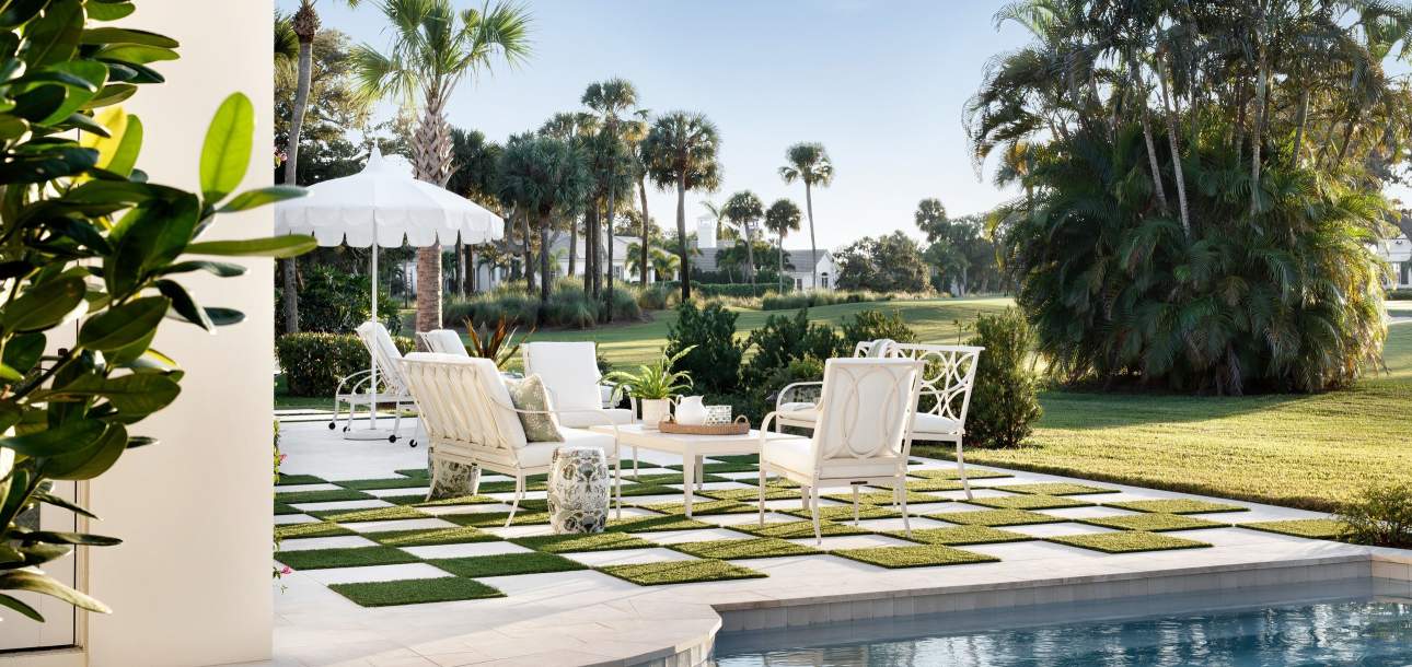 Group of McKinnon and Harris lounge furniture poolside on a terrace at a home in Vero Beach, Florida. Design by VB Home Design Group, Photo by Jessica Glynn / JBSA