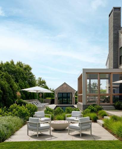 McKinnon and Harris Couper Club Chairs around a fire pit on a stone terrace at a home in Nantucket