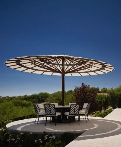 McKinnon and Harris Buie Dining Arm and Side Chairs around a round table at a modern home in Las Vegas, Nevada. Architecture and Interior Design by Daniel Joseph Chenin, Photo by Douglas Friedman