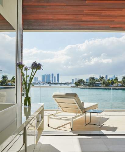 Image of the back of a deCamp Sun Chaise poolside overlooking the ocean. Architecture and Interior Design by Ingrao Inc., Photo by Genevieve Garruppo