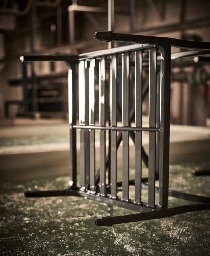 Image of a chair being submerged in the Bonderite EC² Titanium Undercoat process being applied to high-performance furniture frames for maximum longevity. Shown in the McKinnon and Harris Workshop in Richmond, Va