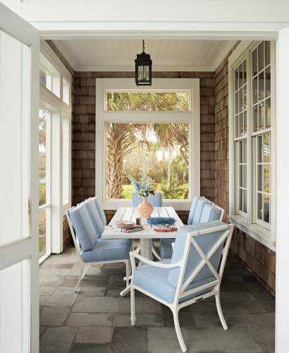 McKinnon and Harris Beaufort Dining Chairs around a Tangier Dining Table. Finished in Classic White with Porto Equator Fabric. At a home in Ponte Vedra Beach, Florida, designed by Emily Painter and photographed by Blake Shorter.