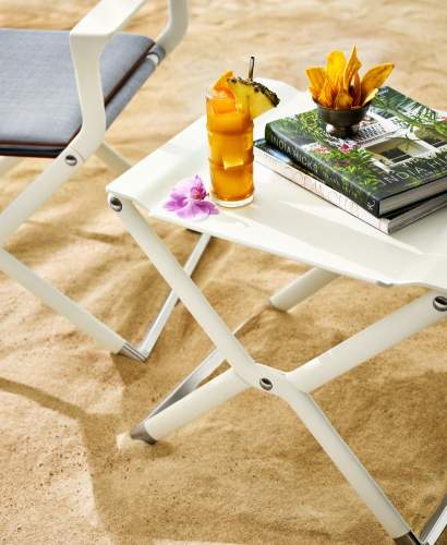 McKinnon and Harris Folding Yacht Table with a Goombay Smash cocktail on top of it