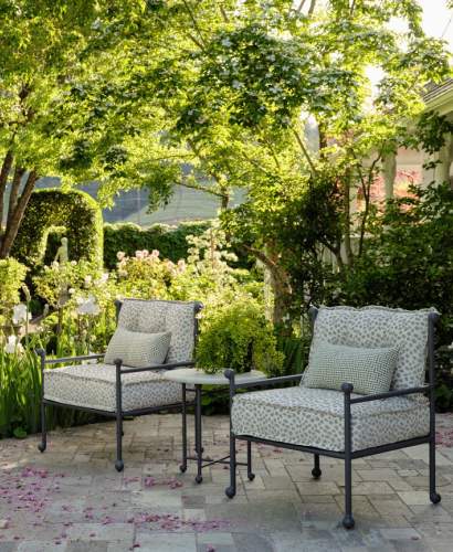 McKinnon and Harris Thirza Club Chairs and Thirza Side Table with Natural Stone Top at a garden in Napa Valley, CA. Design by Suzanne Tucker / Tucker & Marks.