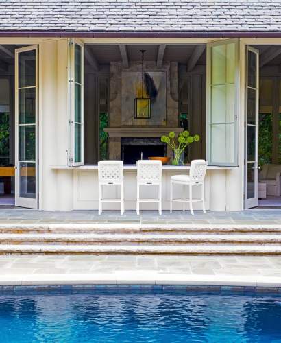 McKinnon and Harris duVal Tall Chairs at a poolside bar at a home in Charlotte, NC. Design by Suzanne Kasler.