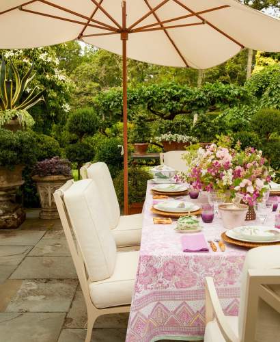 McKinnon and Harris Beaufort Dining Chairs in Charlotte Moss's home garden in East Hampton, NY.