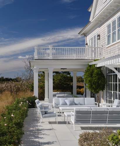 deCamp Sofa and Club Chairs arranged as a seating area on a stone patio. Design by Victoria Hagan