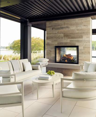 deCamp Lune Collection on a screen porch with a fireplace burning