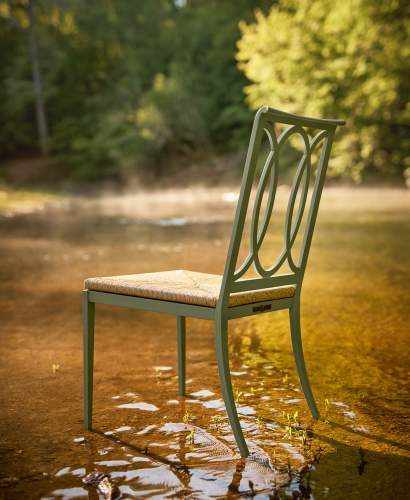 Buie Dining Side Chair with High Performance Rush Seat finished in Shenandoah Gray Green placed in a creek to show its performance