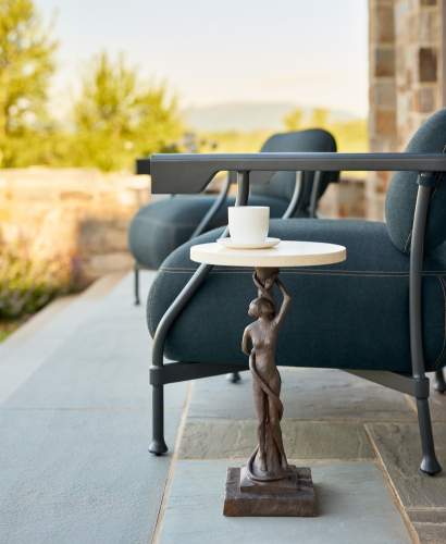 Image of Sculptura NoIII Drinks Table and Bastille Club Chairs on a stone terrace