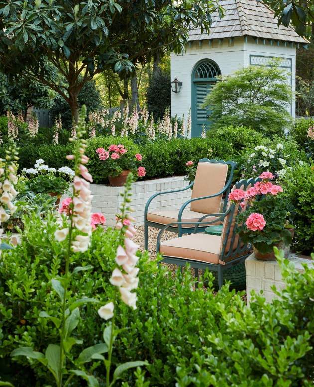 Graves Dining Arm Chairs in a lush garden. Design by James Farmer, Photo by Emily Followill