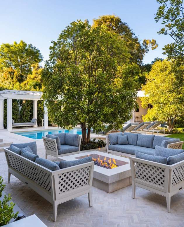 McKinnon and Harris duVal-Alexander Sofa and Club Chairs with Trellis Back on a stone terrace with a fire pit. Design by Josh Brown Design, Landscape Architecture by Hoffman & Ospina, Architecture by Domani Architecture, Photo by Manolo Langis