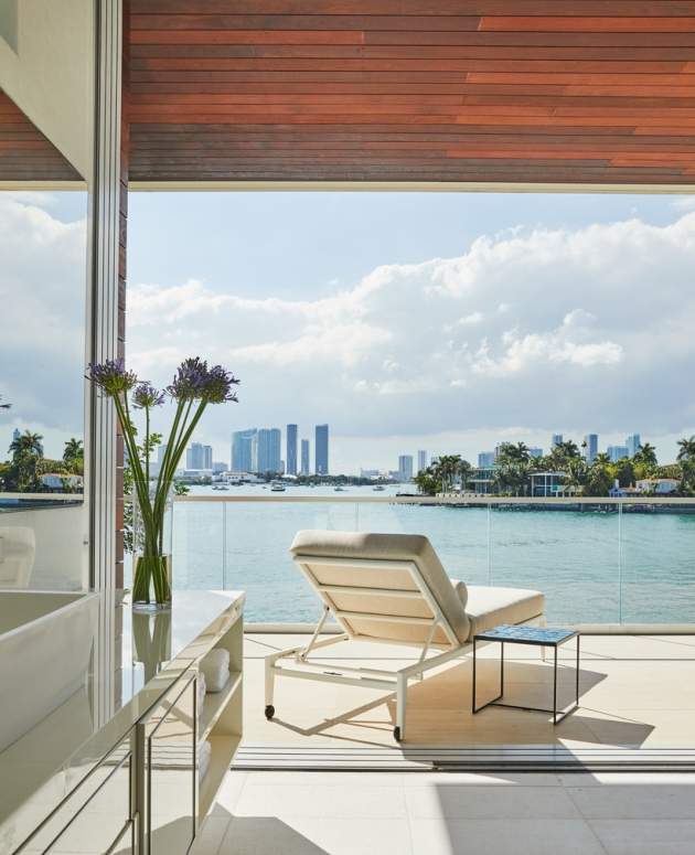 Modern home in Miami with McKinnon and Harris deCamp Sun Chaise poolside. Design by Ingrao