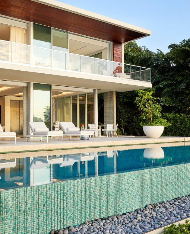 Modern home in Miami with McKinnon and Harris furniture poolside. Design by Ingrao