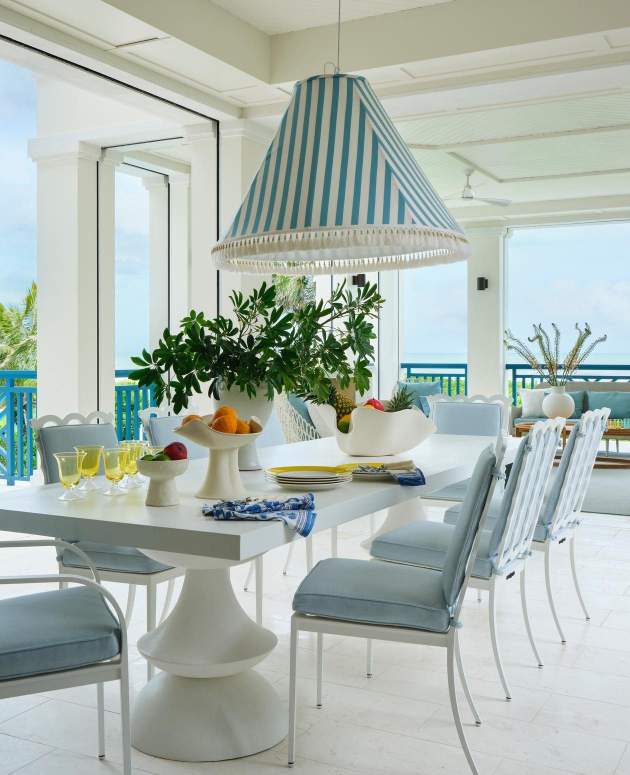 Image of Graves Dining Chairs and a modern dining table under a covered outdoor area. Design by Janie Molster Interiors, Photo by Brantley Photography