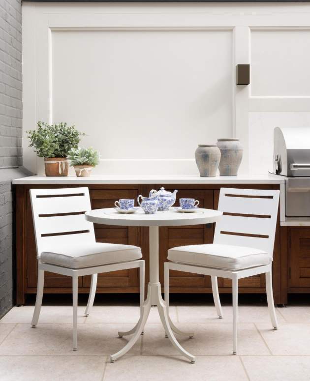 Fayette Dining Side Chairs and Feolin Cafe Table shown at Humphrey Munson showroom in London, England