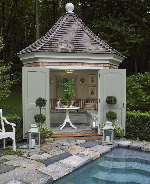 McKinnon and Harris Feolin Cafe Table finished in Classic White inside a cake house poolside. Design by Cathy Kincaid Interiors.