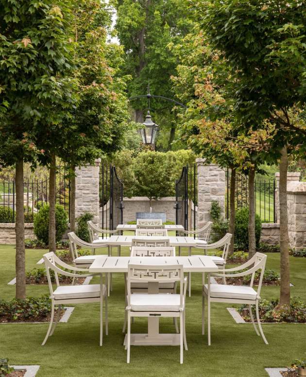 McKinnon and Harris Abbot Dining Arm Chairs and Carroll Square Dining Tables on a vast green lawn. Design by Beth Webb, Landscape Architecture by Stephen Hackney, Architecture by Stanley Dixon, Photo by Lisa Romerein/OTTO
