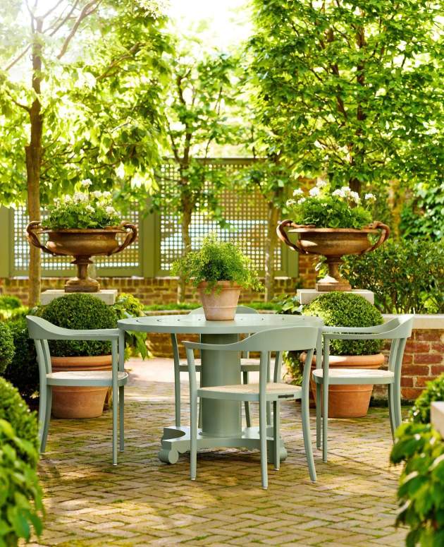 McKinnon and Harris Chesapeake Dining Arm Chairs with a round dining table in co-founder Will Massie's garden