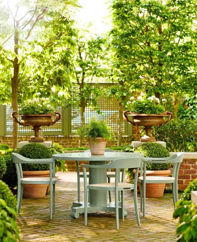 Chesapeake Dining Arm Chairs with Rush Seat and Albemarle Round Dining Table finished in our co-founder Will Massie's Garden