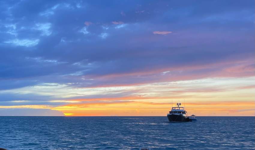 Image of a Yacht Sailing off into the sunset