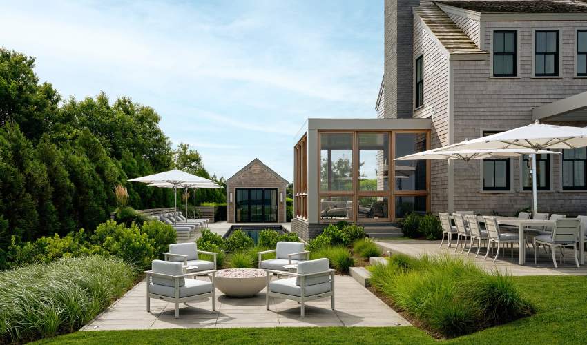 Couper Club Chairs around an outdoor firepit at a home in Nantucket. Architecture and Interior Design by Workshop/APD, Photos by Read McKendree / JBSA