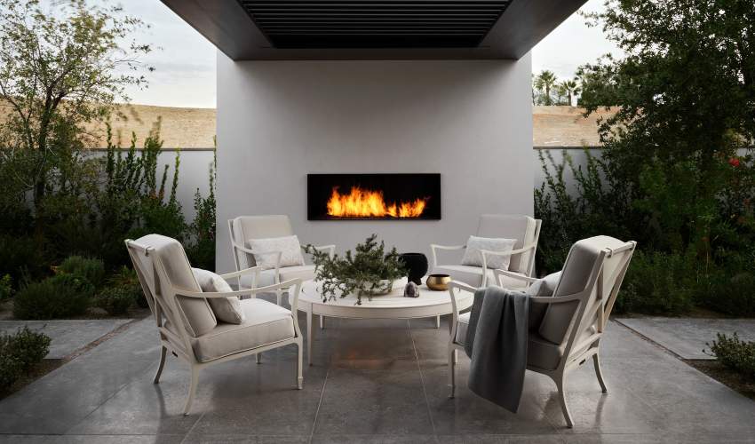 McKinnon and Harris Beaufort Club Chairs and Wyatt Round Coffee Table next to a fire source at a modern home in Las Vegas, Nevada. Design by Daniel Joseph Chenin.