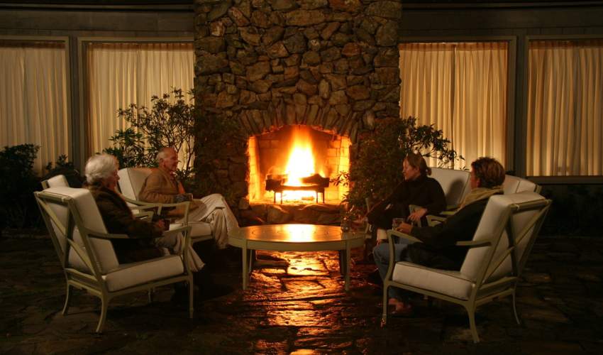 The Massie family gathered around an outdoor fireplace