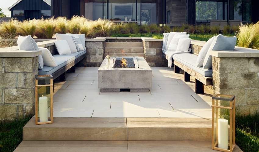 McKinnon and Harris throw pillows and fabrics surrounding an outdoor firepit