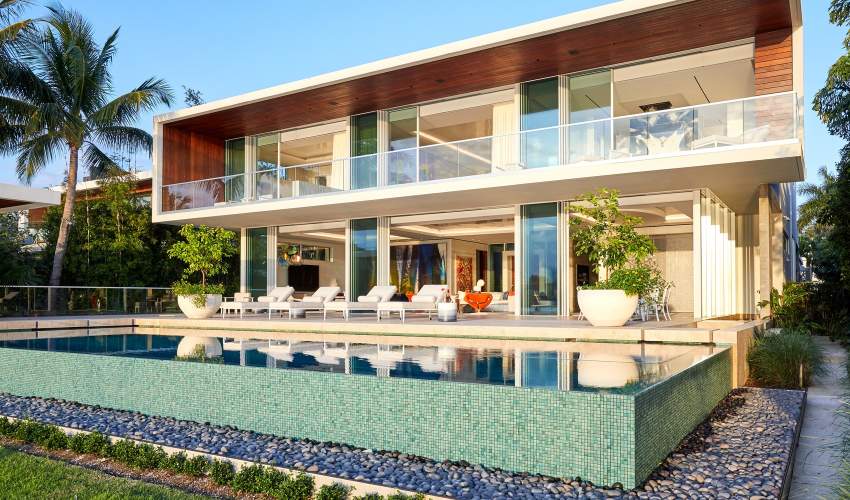 Modern home in Miami with McKinnon and Harris furniture poolside. Design by Ingrao