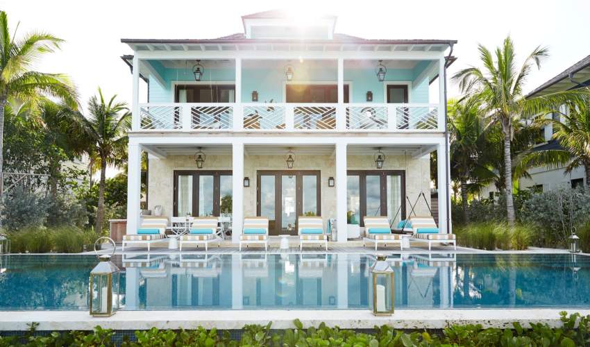 McKinnon and Harris duVal Sun Chaises with a striped fabric poolside at a home in the Bahamas. Design by Marshall Watson.