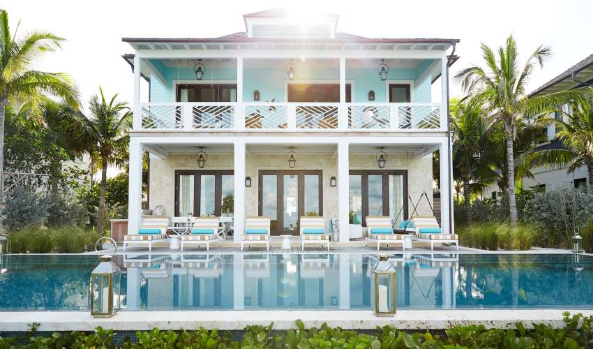 duVal Sun Chaises with a striped fabric poolside at a home in the Bahamas. Interior Design by Marshall Watson and Kate Reid, Photo by Francesco Lagnese / Otto