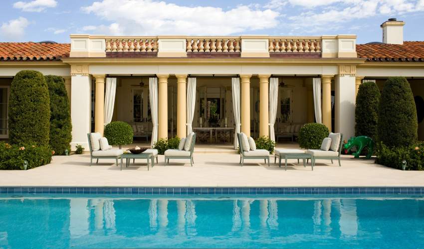 duVal Armless Club Chairs and Ottomans and Wyatt Square Coffee Tables poolside. Interior Design by Aman & Meeks, Photo by Roger Davies Photography/Otto