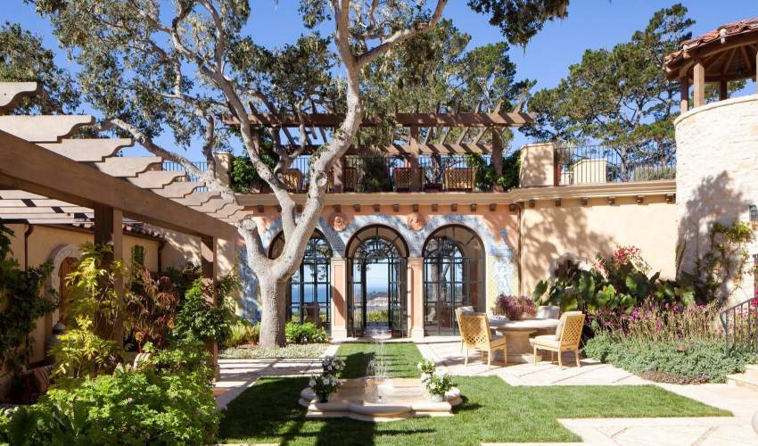 McKinnon and Harris duVal Dining Chairs in a courtyard garden designed by Juan Pablo Molyneux.